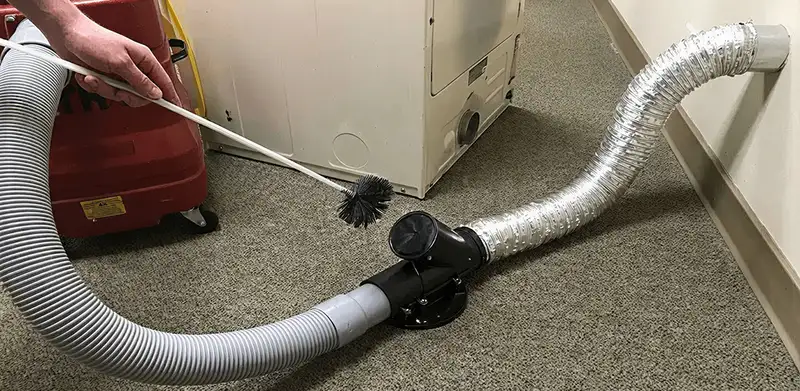 Dryer vent cleaning service removing lint from a dryer duct connection in Houston, TX