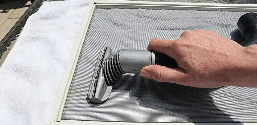 Window screen repair cleaning and fixing a damaged screen mesh in Houston, TX